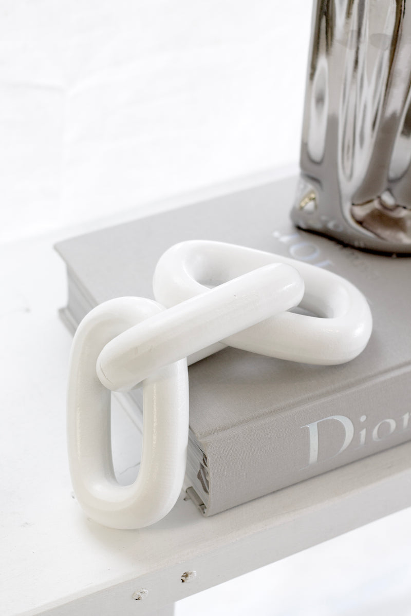 Handcrafted white wooden chain ornament styled on Dior book – modern decorative accent for shelves and coffee tables