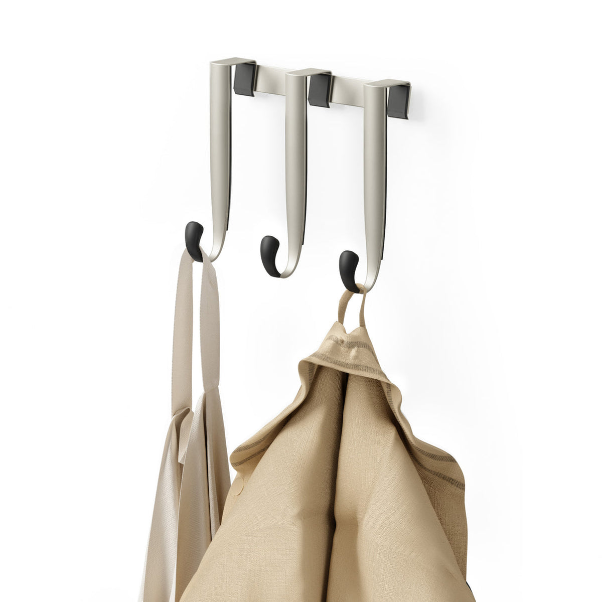 Umbra Schnook over-the-door hooks in nickel holding a linen bag and a jacket