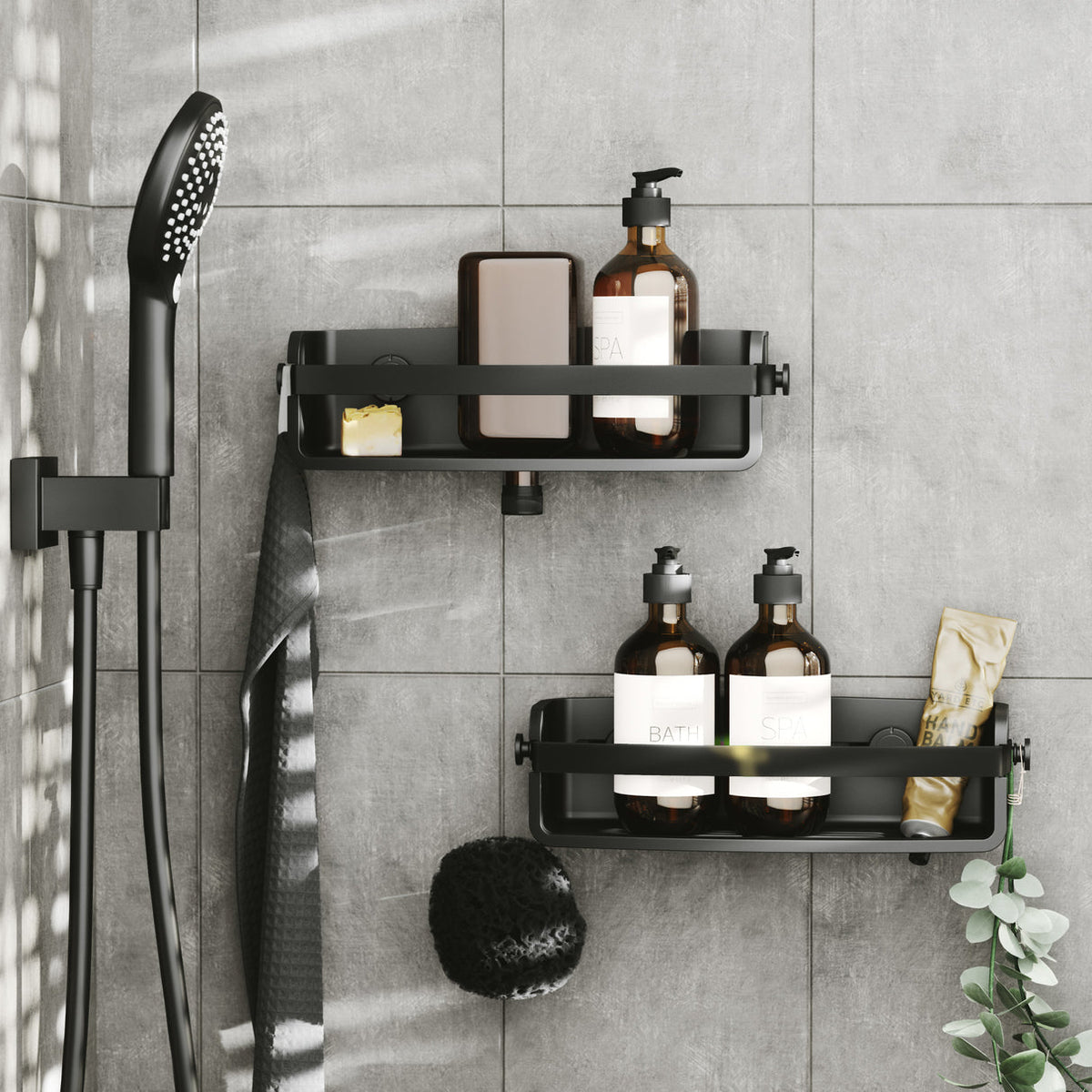 Two Umbra Flex shower bins in black in a tiled shower with bottles, soap and a sponge