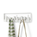 A Skyline Wall Mounted Hook for small spaces with a bag attached made by Umbra.