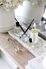 ZAKKIA Terrazzo Square Tray in Seashell styled with skincare bottles, diffuser, and hydrangea vase – neutral terrazzo home styling
