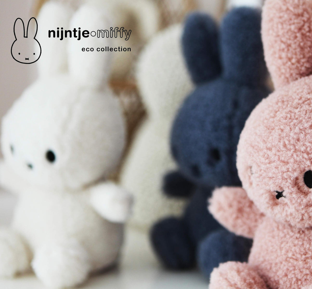 Miffy plush toys in cream, navy and pink lined up together