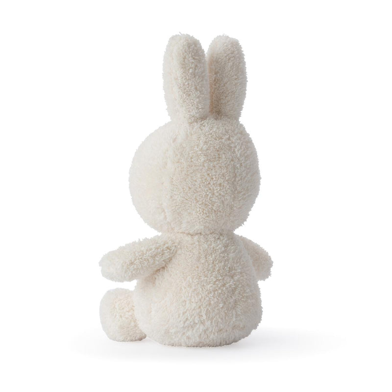 A Miffy Sitting Terry Cream (23cm) bunny, produced by Mr Maria, sitting on a soft white surface.