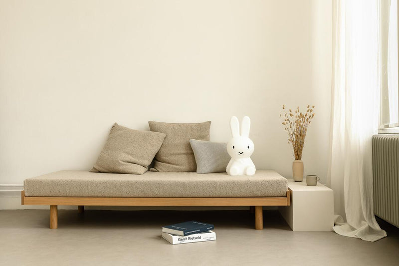 A medium sized white couch with a white teddy bear sitting on it, designed with a Mr Maria Miffy Star Light - DIMMABLE, MOOD LIGHTING.
