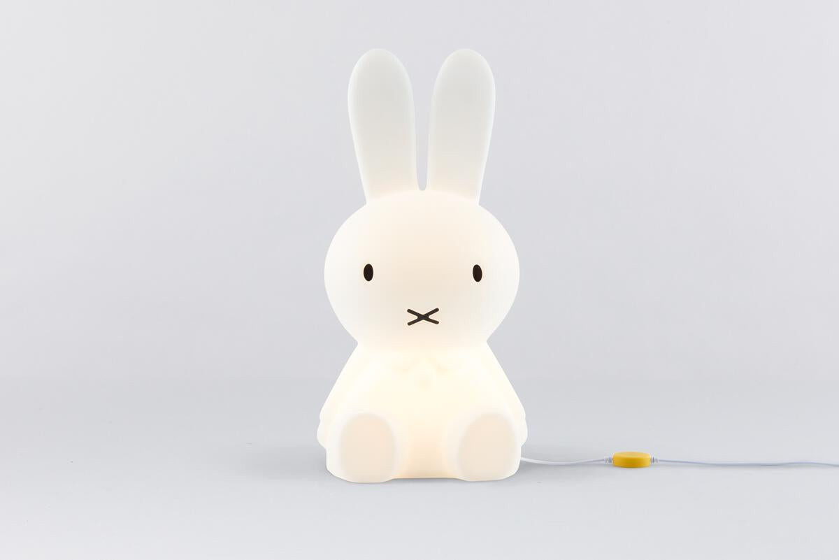 Mr Maria Miffy Star Light on a pale grey floor with its yellow touch dimmer on the cable