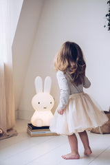 A medium-sized Miffy Star Light - DIMMABLE, MOOD LIGHTING designed with a little girl standing in front of it. (Brand: Mr Maria)