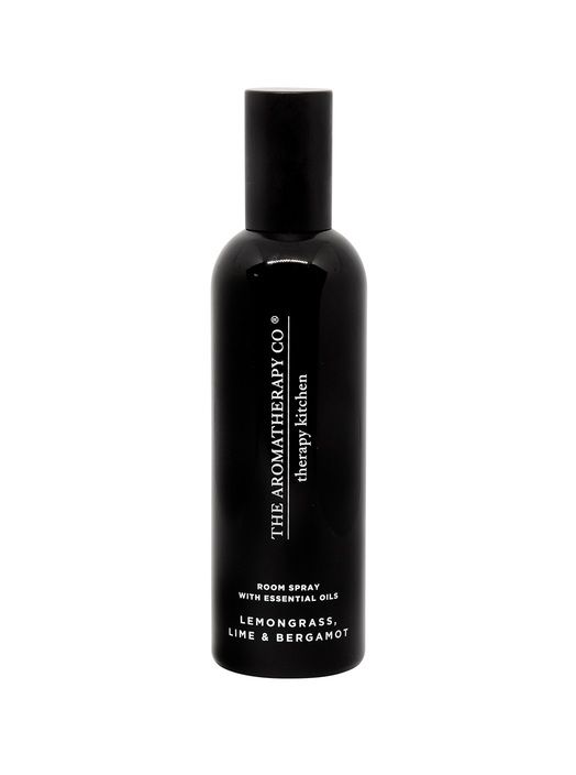 A zesty blend of Therapy® Kitchen Room Spray - Lemongrass, Lime & Bergamot in a black bottle on a white background, by The Aromatherapy Co.