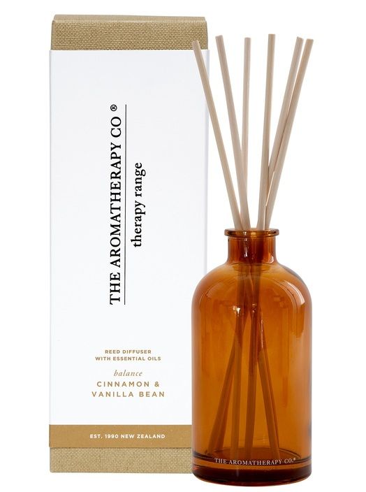 Therapy Balance Cinnamon & Vanilla Bean reed diffuser in amber glass in front of its white and tan box