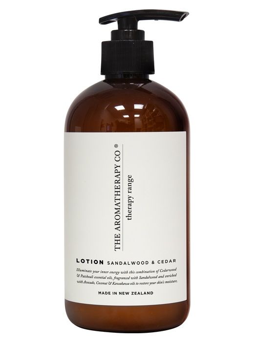 A bottle of Therapy® Hand & Body Lotion - Sandalwood & Cedar with a black handle infused with Sandalwood from The Aromatherapy Co.