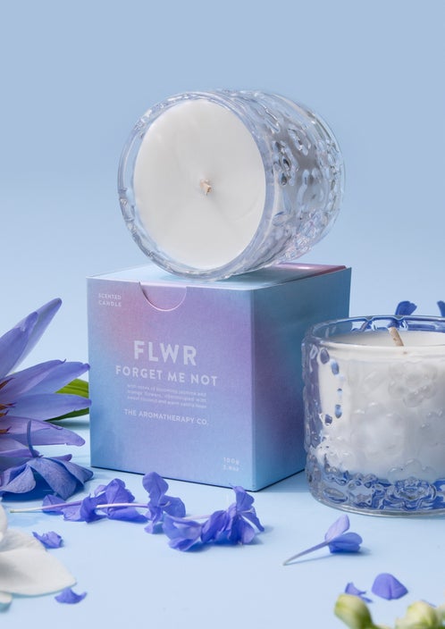 The Aromatherapy Co's FLWR Candle - FORGET ME NOT, scented soy wax blend features blooming jasmine with a hint of vanilla bean.