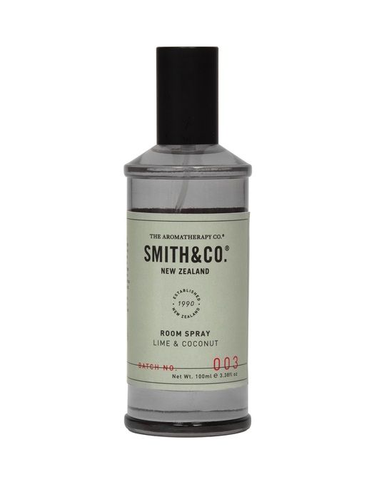 A bottle of The Aromatherapy Co Smith & Co Room Spray - Lime & Coconut stands elegantly on a white background.