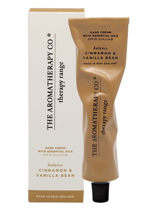 Therapy Balance Cinnamon & Vanilla Bean hand cream in a crinkled metallic caramel tube beside its box