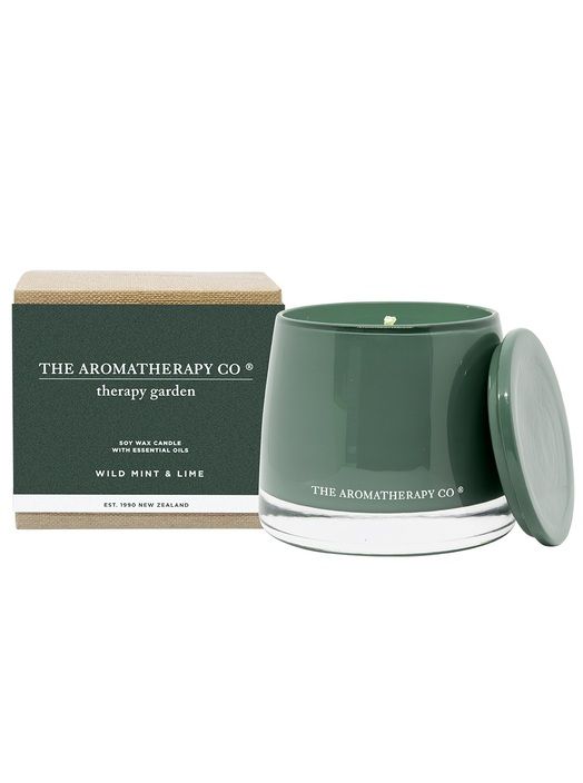 Therapy Garden Wild Mint & Lime candle in deep green glass with its lid, beside its green box