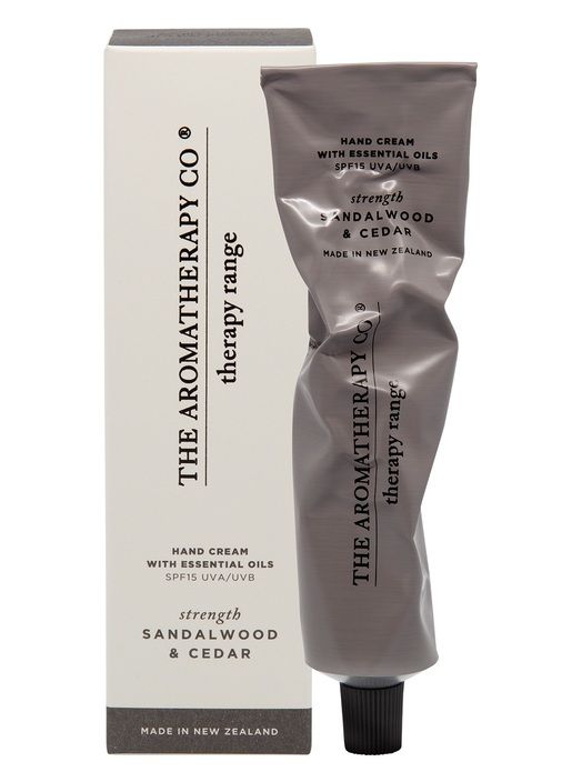 A tube of Therapy® Hand Cream Strength - Sandalwood & Cedar by The Aromatherapy Co, infused with essential oils, providing SPF 15 protection for the skin, placed in front of a box.