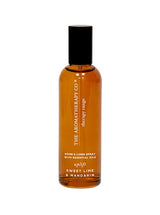 A bottle of Therapy® Linen & Room Spray Uplift - Sweet Lime & Mandarin by The Aromatherapy Co with a brown bottle on a white background.