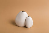 Two Great Harmie Vases - White / Natural from Ned Collections on a beige background.