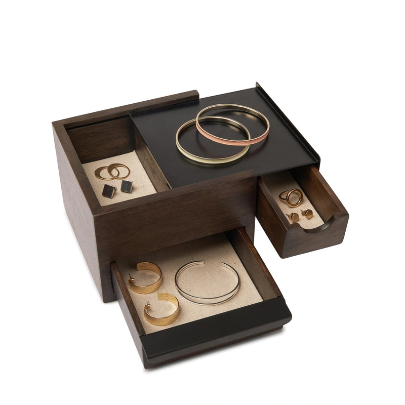 An Umbra MINI STOWIT JEWELRY BOX WALNUT/BLACK with several rings and bangles.