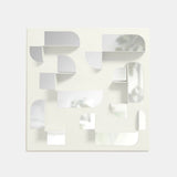 A white Umbra wall mounted mirror with laser-cut geometric shapes on it.