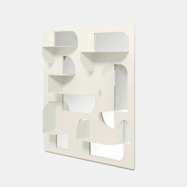 A white Umbra wall mounted mirror adorned with laser-cut geometric shapes.