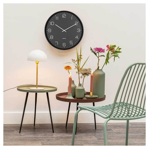 Aesthetic and minimal Karlsson Lofty Wall Clock - Black (40cm) displayed next to a green vase.