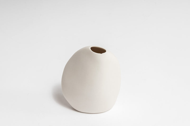 A Great Harmie Vase - White / Natural, handcrafted by Vietnamese artisans, gracefully adorns a white surface as a proud addition to the Ned Collections.