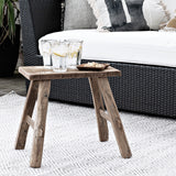 A Flux Home TEAK BENCH SMALL NATURAL next to a couch.