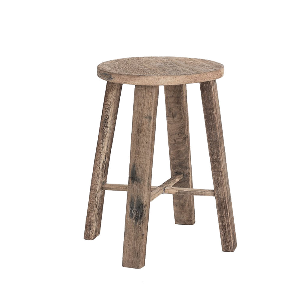 Round teak stool in natural timber with four splayed legs, on a plain background