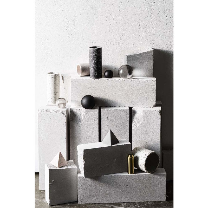 A group of waterproof Terrazzo Vases in Black by Zakkia, stacked on top of each other.