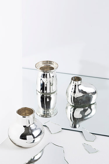 Three Zakkia Bulb Vase Rounded - Silver with tactile finishes sitting on a mirror.