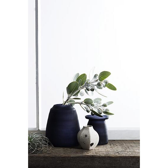 A pair of Zakkia Carved Vase Rounded - Confetti blue vases on a window sill.
