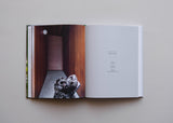 An open Resident Dog | Nicole England book with an image of a dog.