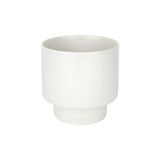 A Zakkia Podium Pot - Medium Glazed White ceramic cup on a white surface.