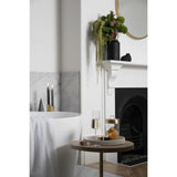A bathroom with a bathtub and a fireplace adorned with Zakkia's Tealight Candle Holder - Set of 3 Black.