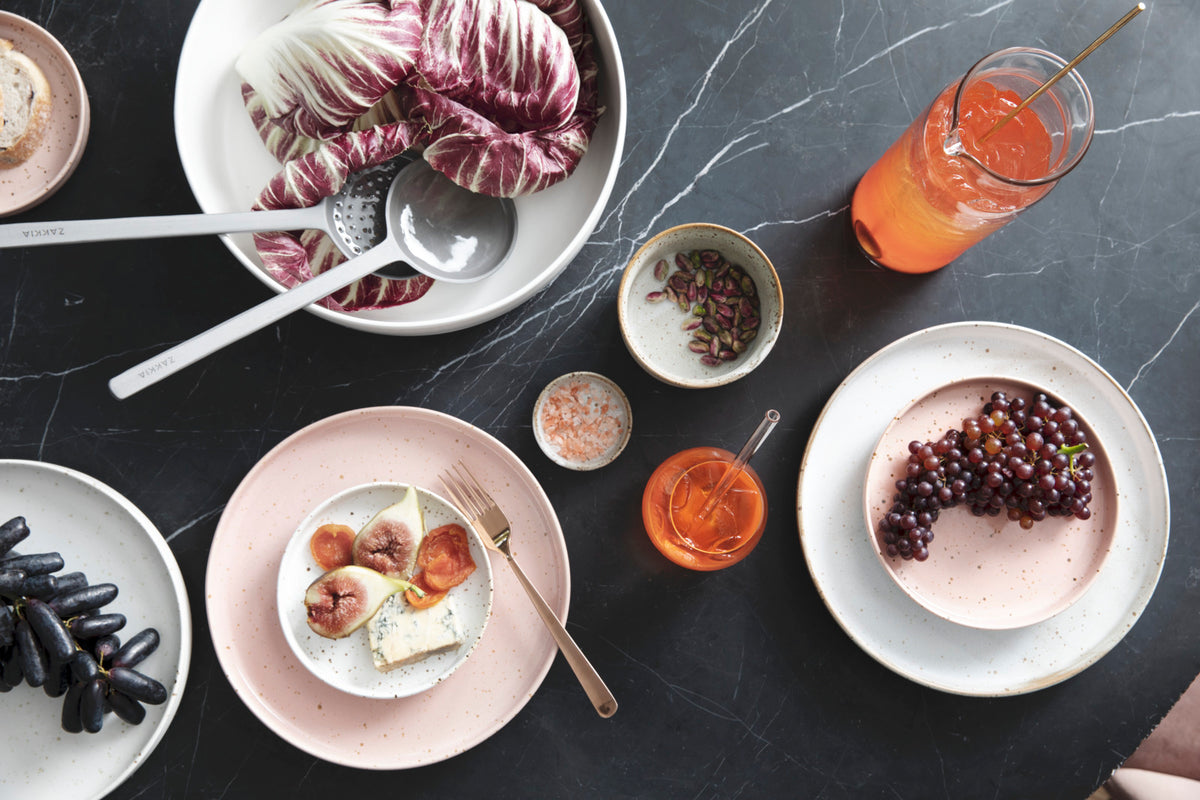 A table full of plates with food on them and Zakkia's Glass Drinking Straws Pack of 6 - Short / Long.