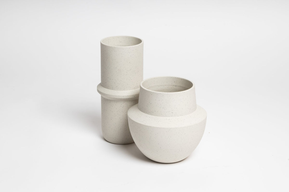Bonnie vase beside a tall cream vase, on white