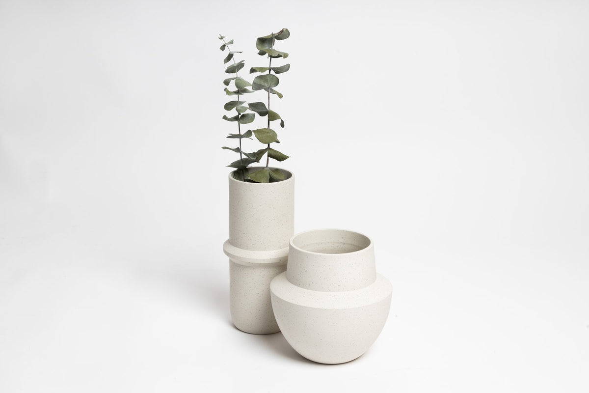 Bonnie vase beside a tall vase of eucalyptus, on white