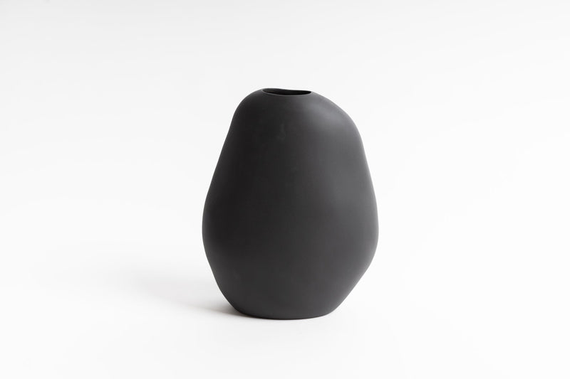 Description: A black Harmie Vase - Various Options on a white background by Ned Collections.
