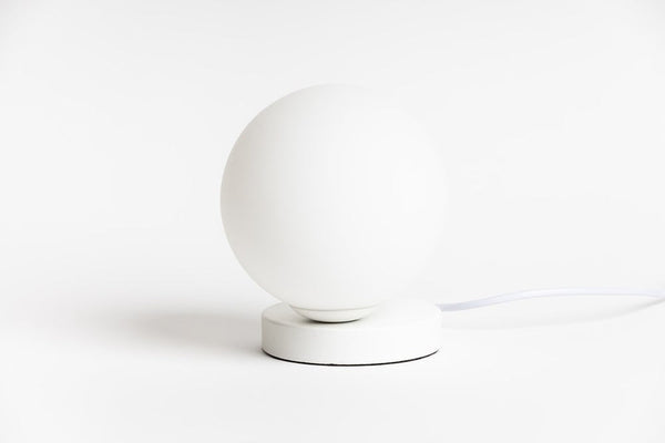 An Yuri Table lamp on a white surface. (Brand Name: Ned Collections)