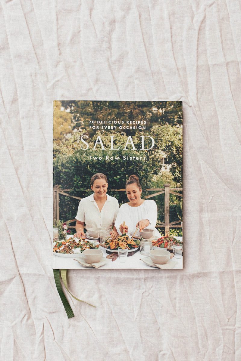 A Salad book cover with two women sitting at a table by Books.