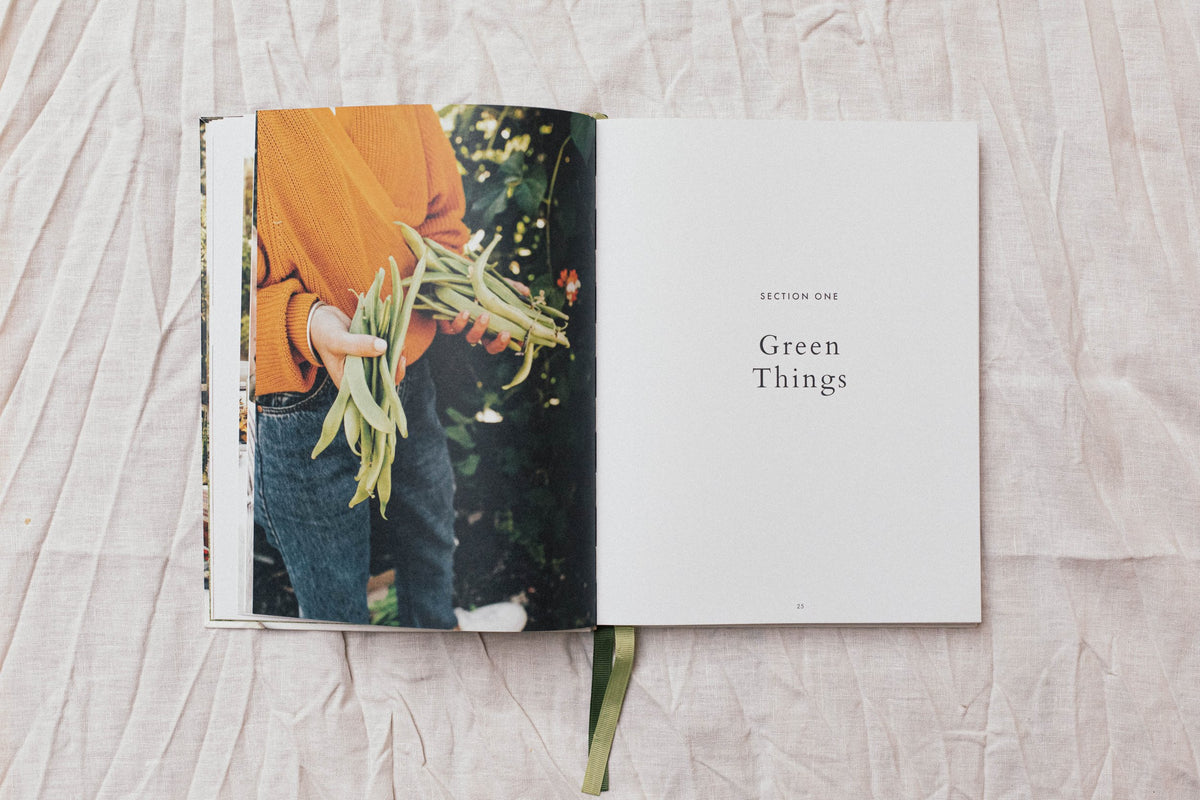 An open book with the words "Salad | 70 delicious recipes for every occasion" by Books on it.