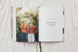 An open salad book with a photo of two people and a flower.