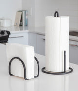 Two Squire Napkin Holders by Umbra on a counter top.