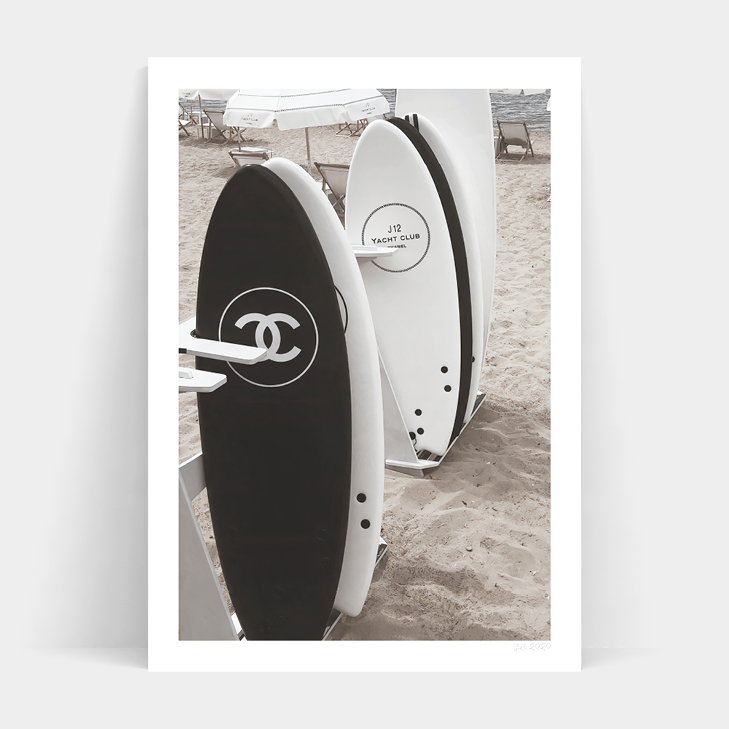Black and white photo of CHANEL SURF CLUB surfboards on the beach by Art Prints.