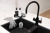 A compostable black kitchen sink with a pack of 2 highly absorbent Barkly Basics Chevron Scourer Sponges.