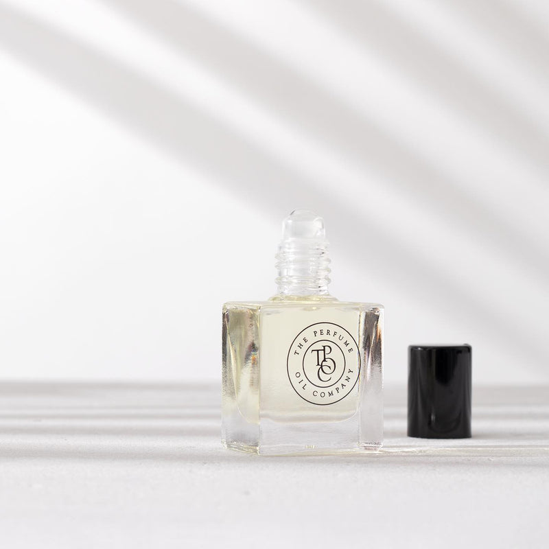 A small bottle of NUDE, inspired by Beige (CC) perfume sitting on a white surface by The Perfume Oil Company.
