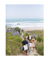 A group of people walking down a Raw & Free path by Books.