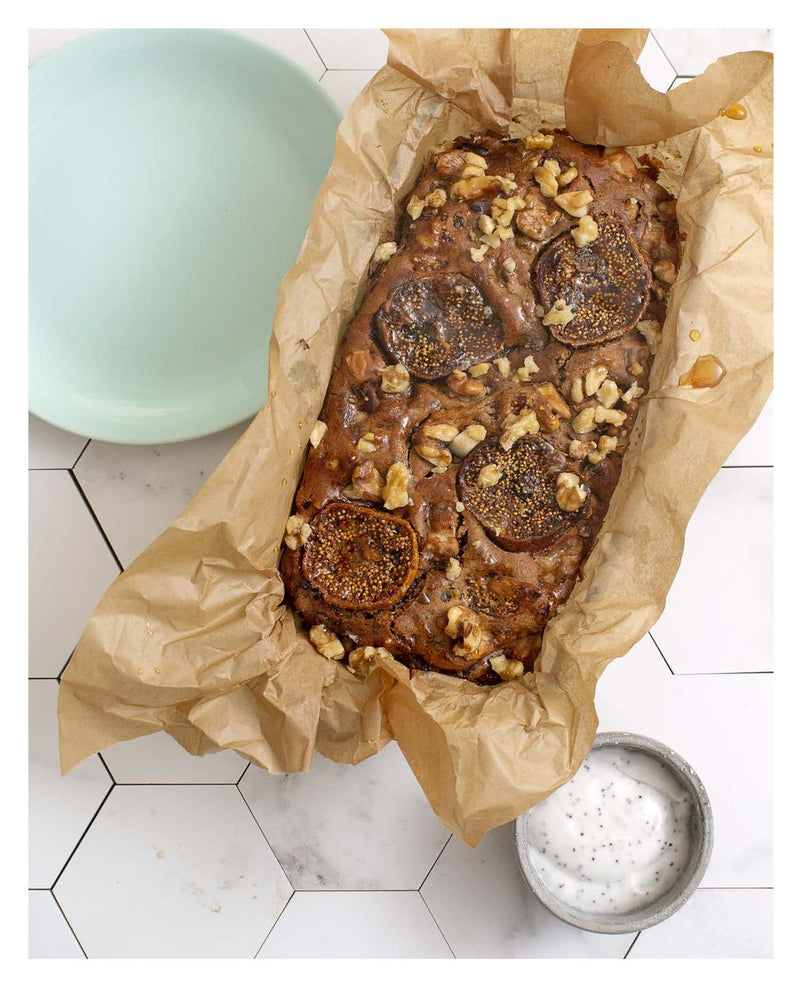 A loaf of Raw & Free plant-based fig and walnut bread is sitting on a table.