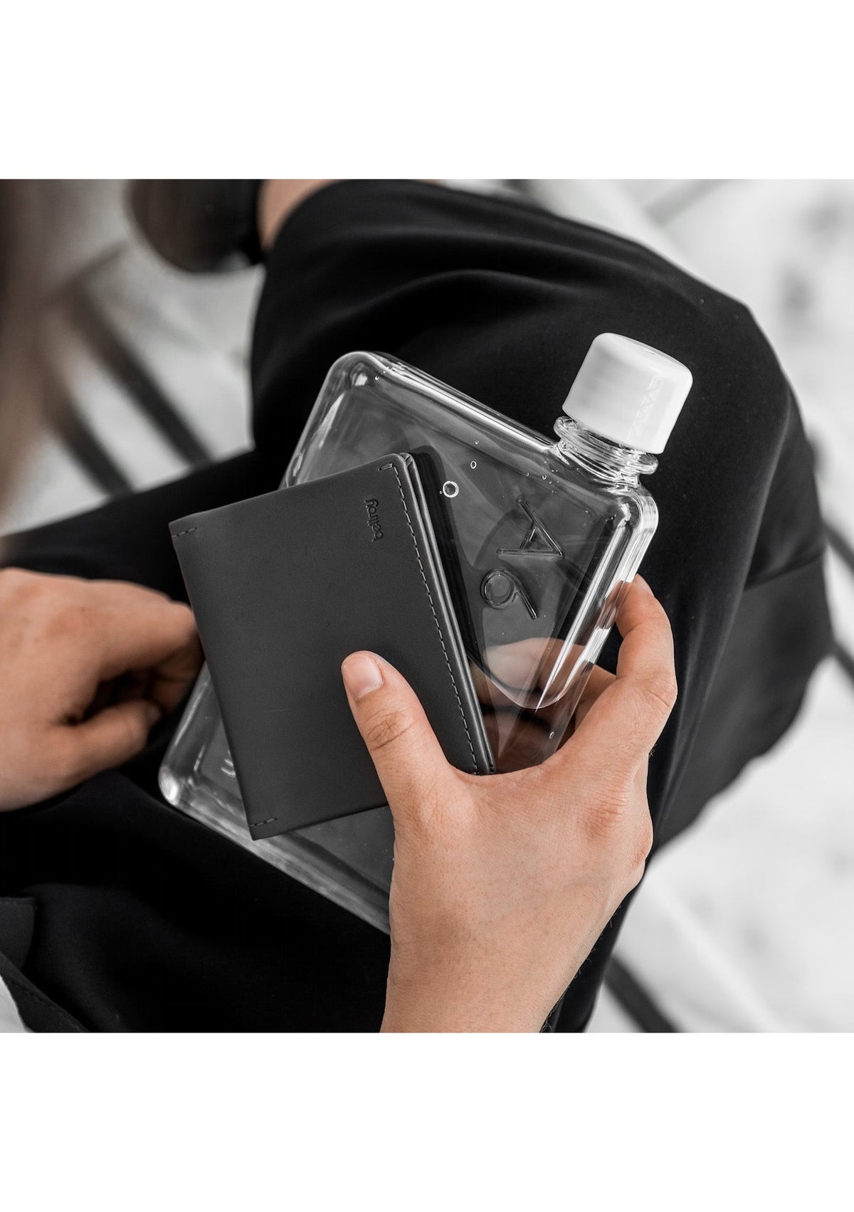 A person holding an A6 MemoBottle with hydration.