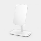 A white MIRROR WITH STORAGE TRAY - Dark Grey / White by Flux Home on a stand with a storage tray on a white background.
