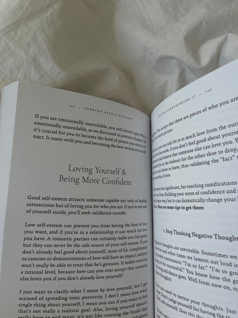 Book open to a spread on white bedding